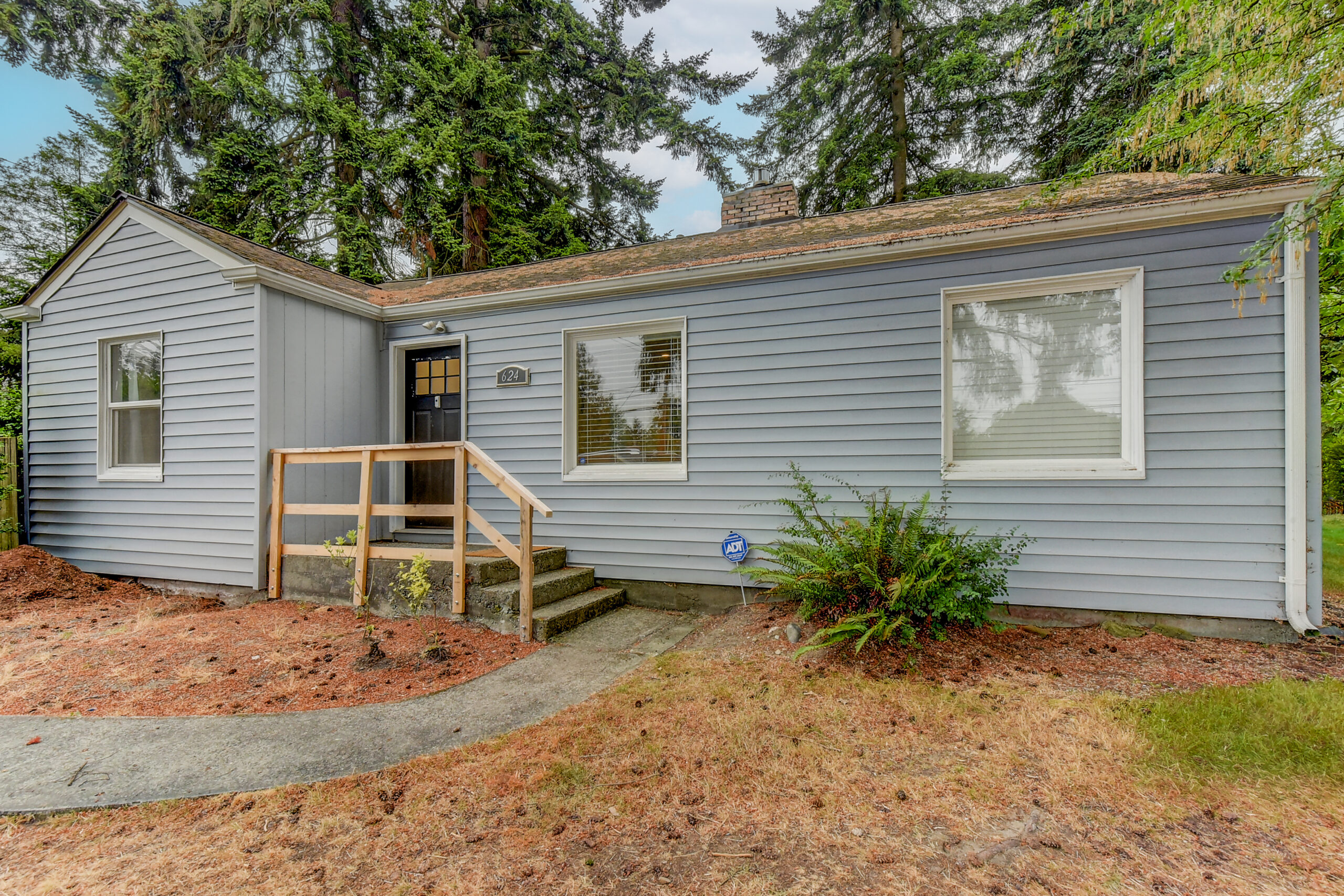 Front exterior of the 624 Madison St rambler in Everett, with new steps and gray siding
