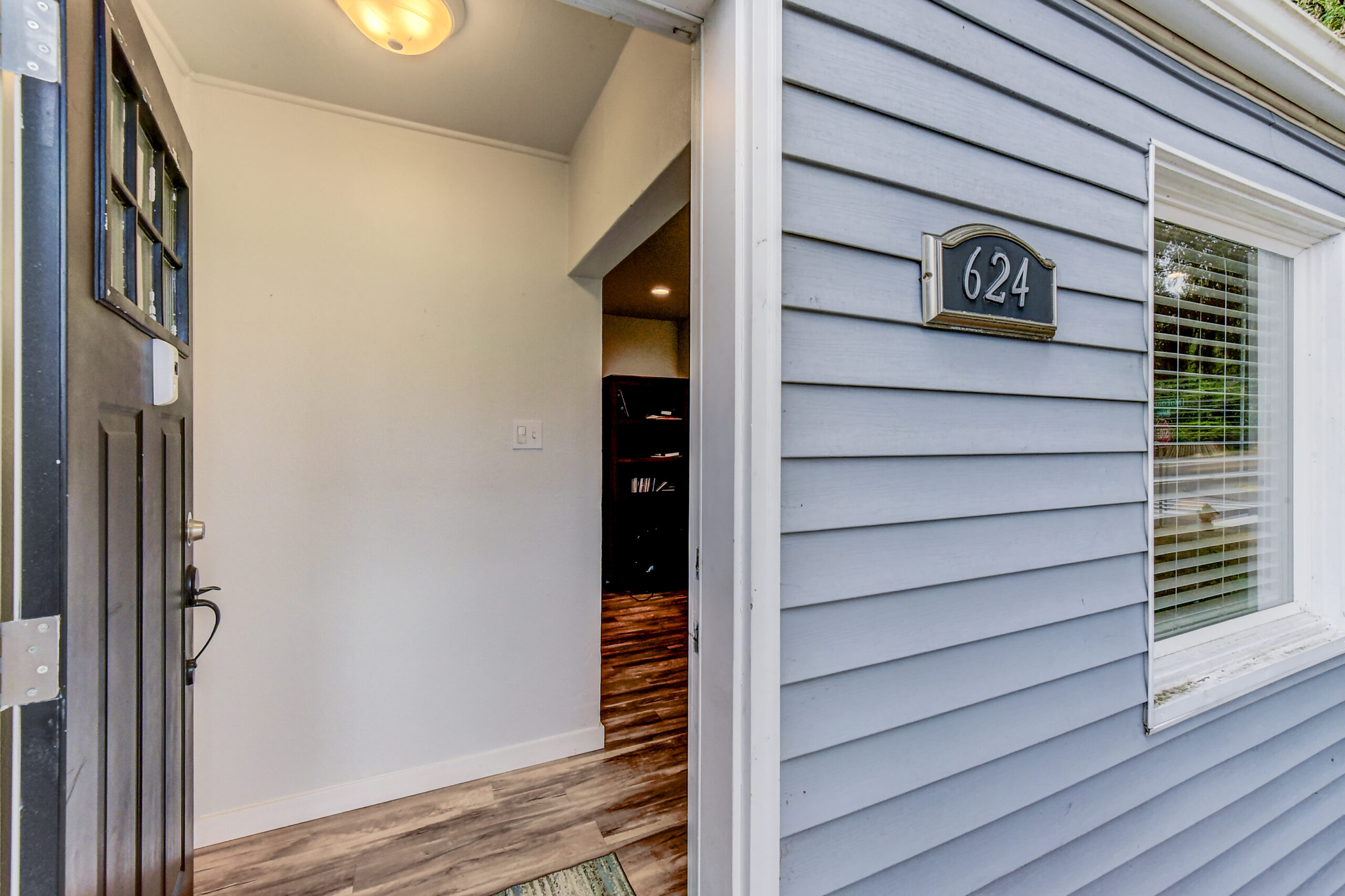 Entryway and address plaque 624 at the Everett rambler, with open front door and hallway