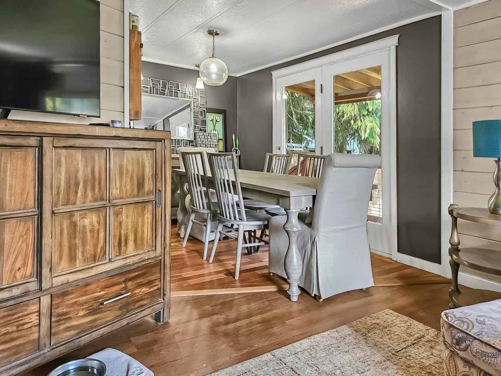 Dining area with wood table, seating, and French doors to deck at the Concrete home