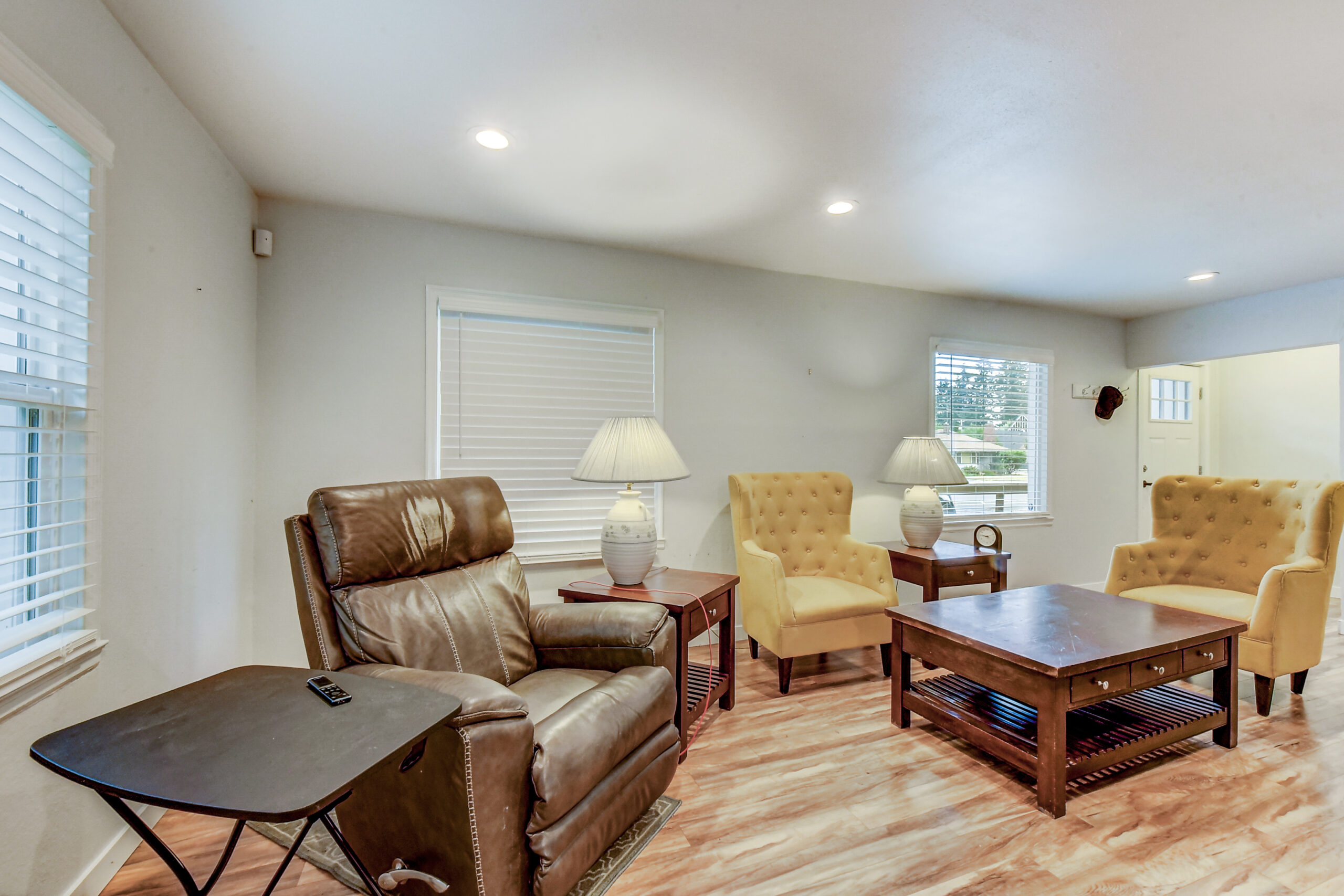 Living room with recliner, armchairs, and coffee tables at the Everett rambler on Madison St