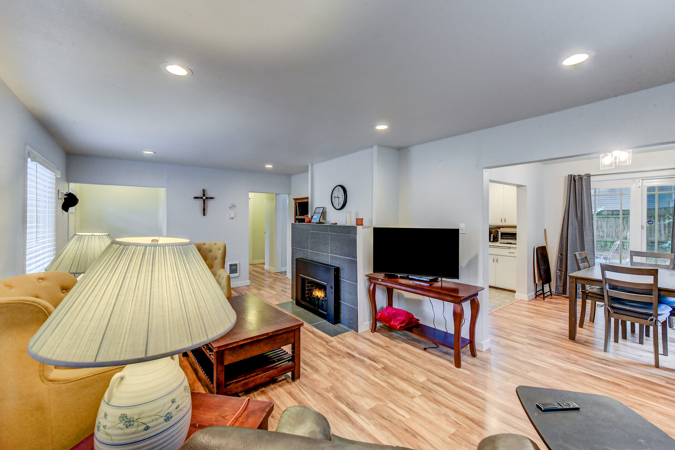 Living room with fireplace and open kitchen at the Everett rambler on Madison St