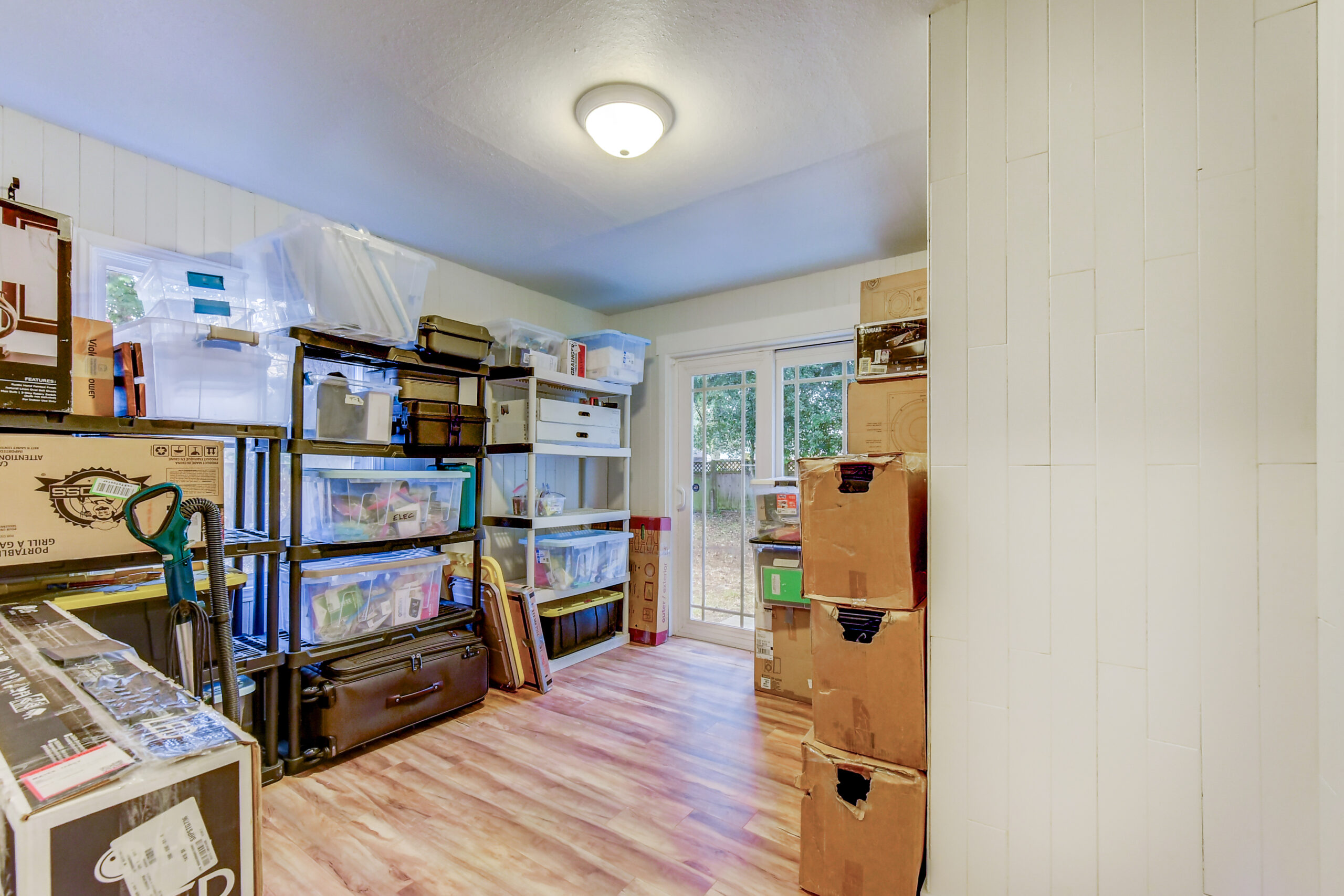 Bonus storage room with shelving and slider to backyard at the Everett rambler
