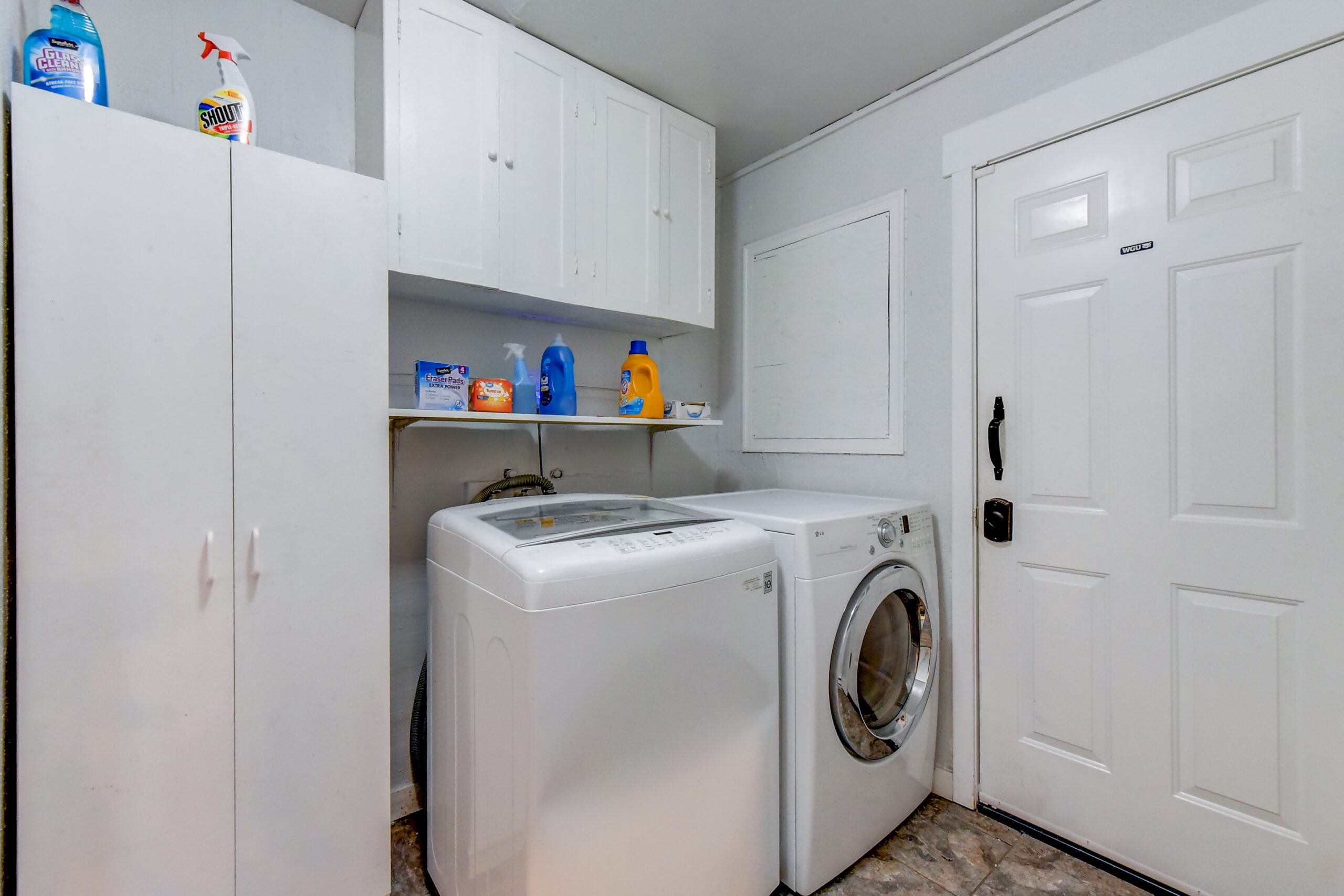 Laundry room with washer, dryer, and storage cabinets at 624 Madison St, Everett home