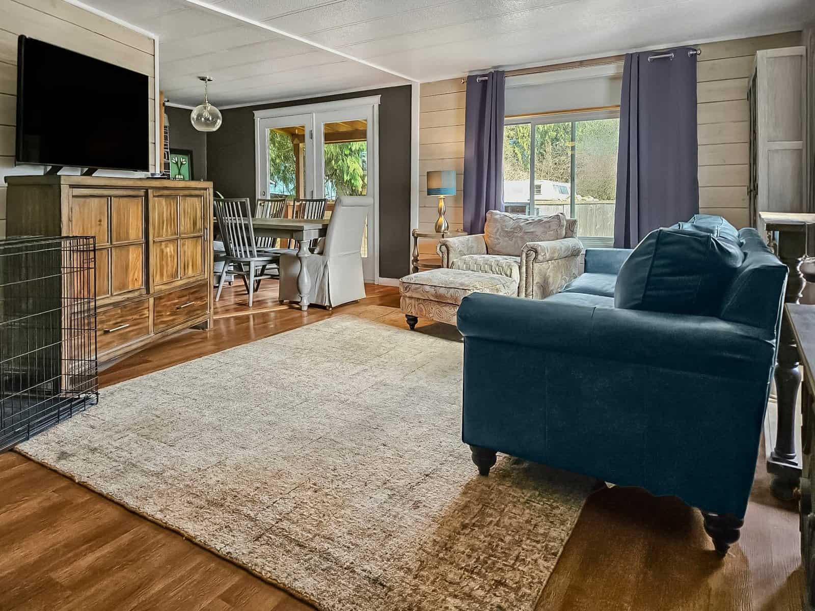 Living room with sofa, armchair, and dining area in the Concrete, WA home