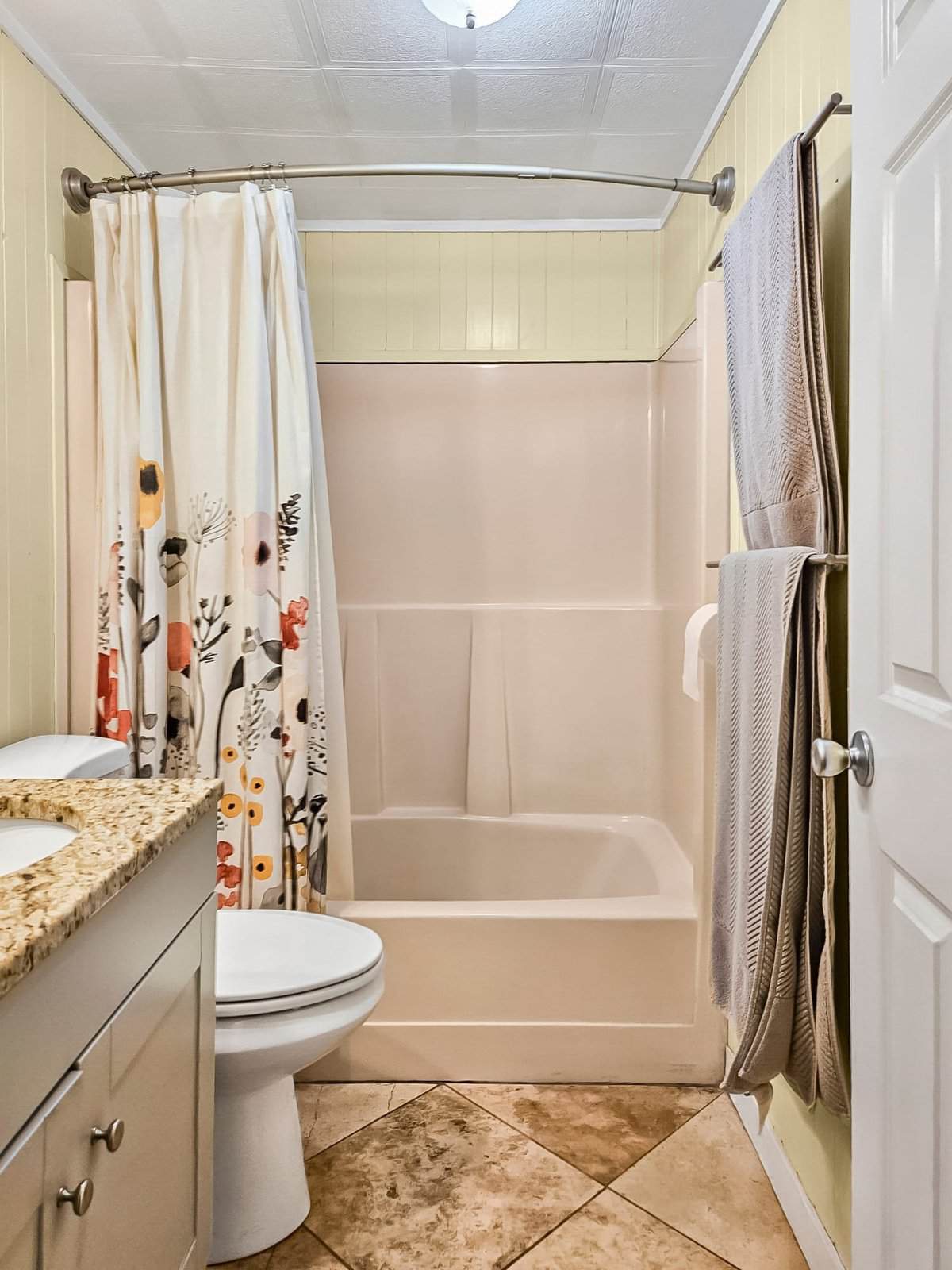 Bathroom with tub/shower combo and granite-top vanity at the Concrete, WA home