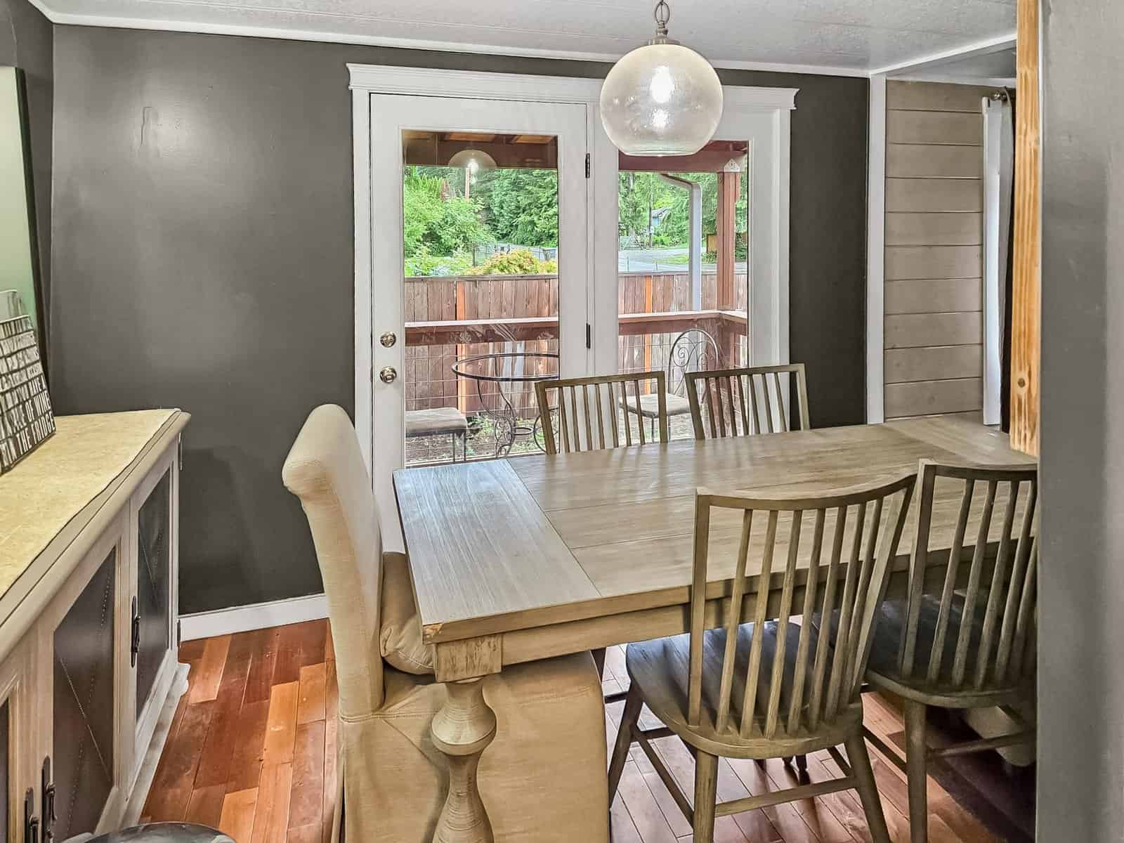 Dining area with wood table and French doors to deck, Concrete home
