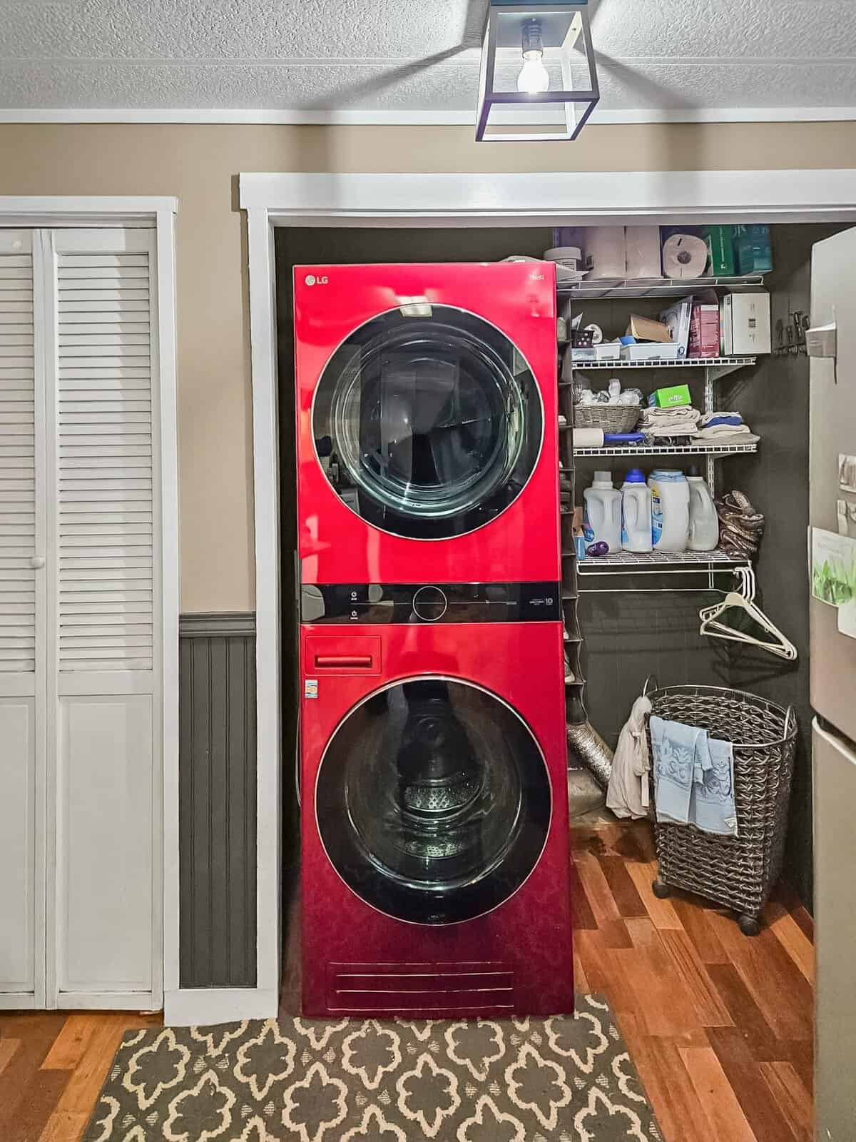 Laundry closet with stacked red LG washer/dryer and shelving at the Concrete, WA home
