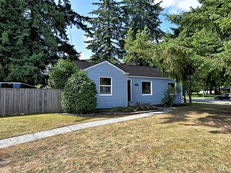 Front exterior of the blue rambler home at 624 Madison St, Everett, with fenced yard and lawn