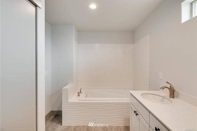 Bathroom with soaking tub and vanity in the Entiat rambler home