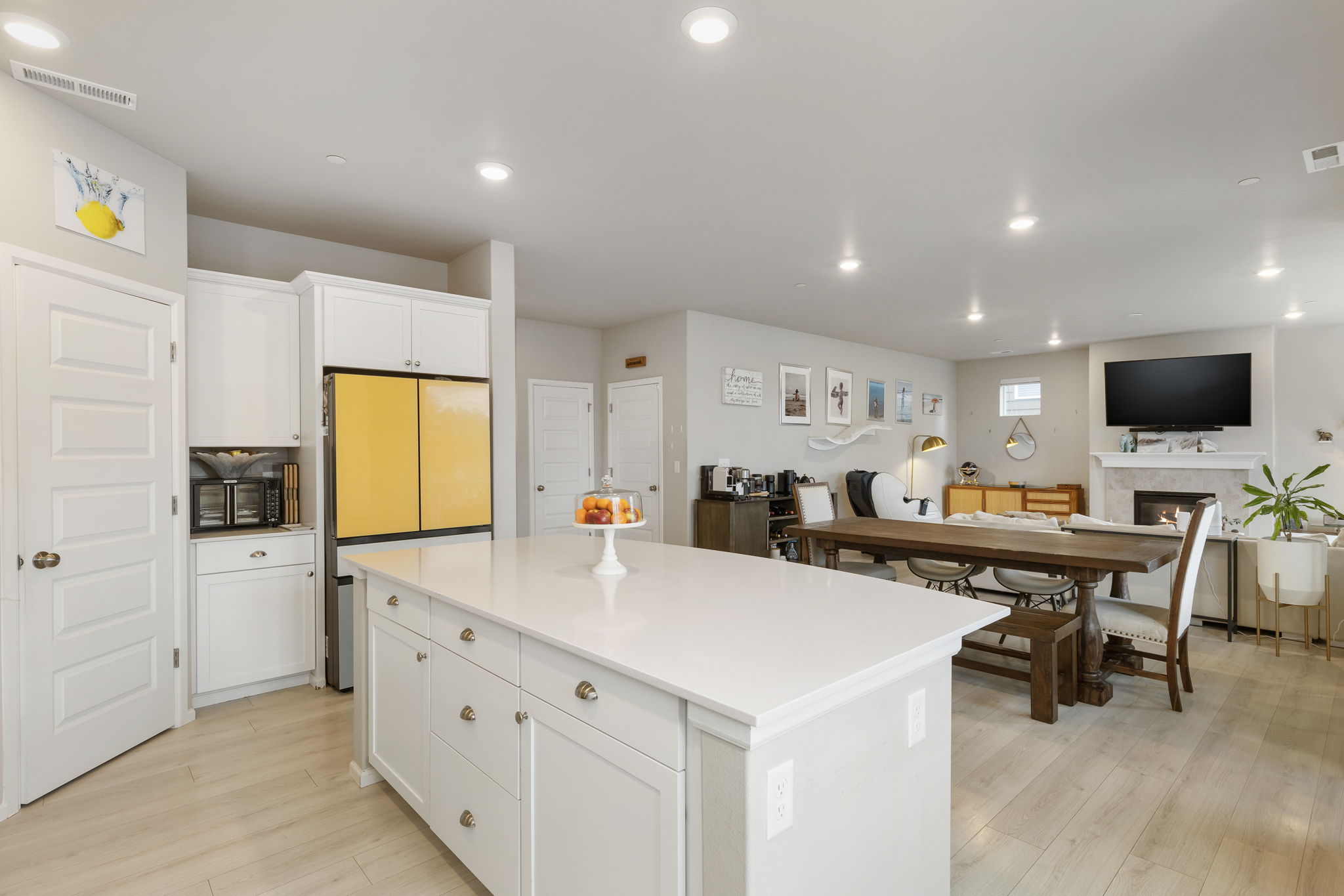 Open kitchen with white island opens to dining and living area in the Port Orchard rent-to-own home