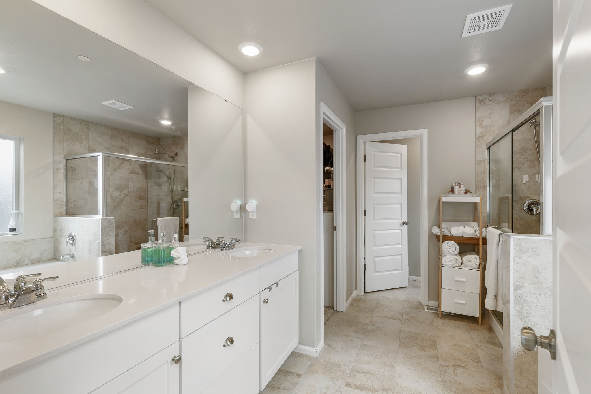Primary bathroom with double-sink vanity and walk-in shower at the Port Orchard rent-to-own home