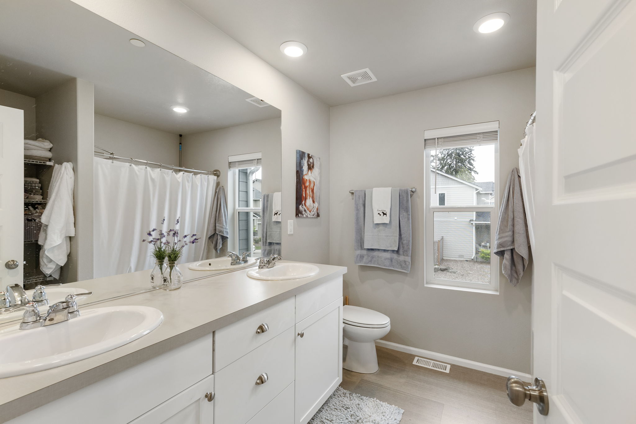 Full bathroom with double-sink vanity in the Port Orchard rent-to-own home at 962 Thrush Ct SE