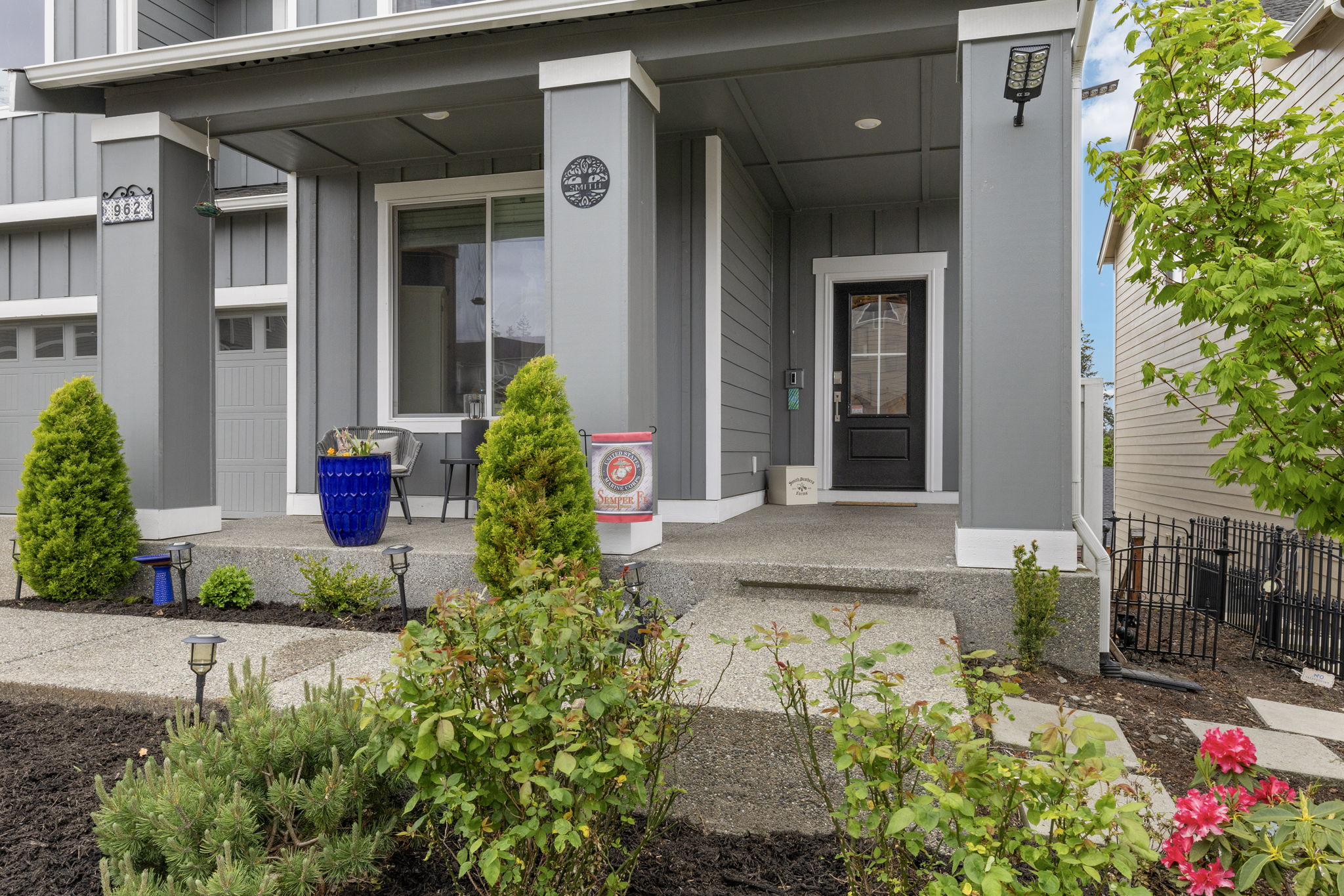 Covered front porch and entry of the Port Orchard rent-to-own home at 962 Thrush Ct SE, with landscaped walkway