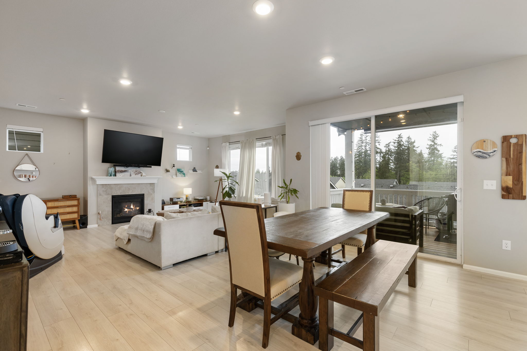 Open dining and living area with fireplace and deck access at the Port Orchard rent-to-own home