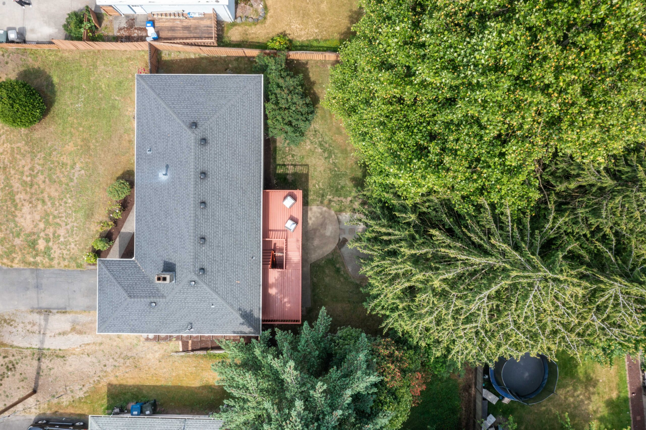 Aerial view of the Auburn duplex roof, deck, and 8,250 sq ft lot with mature trees
