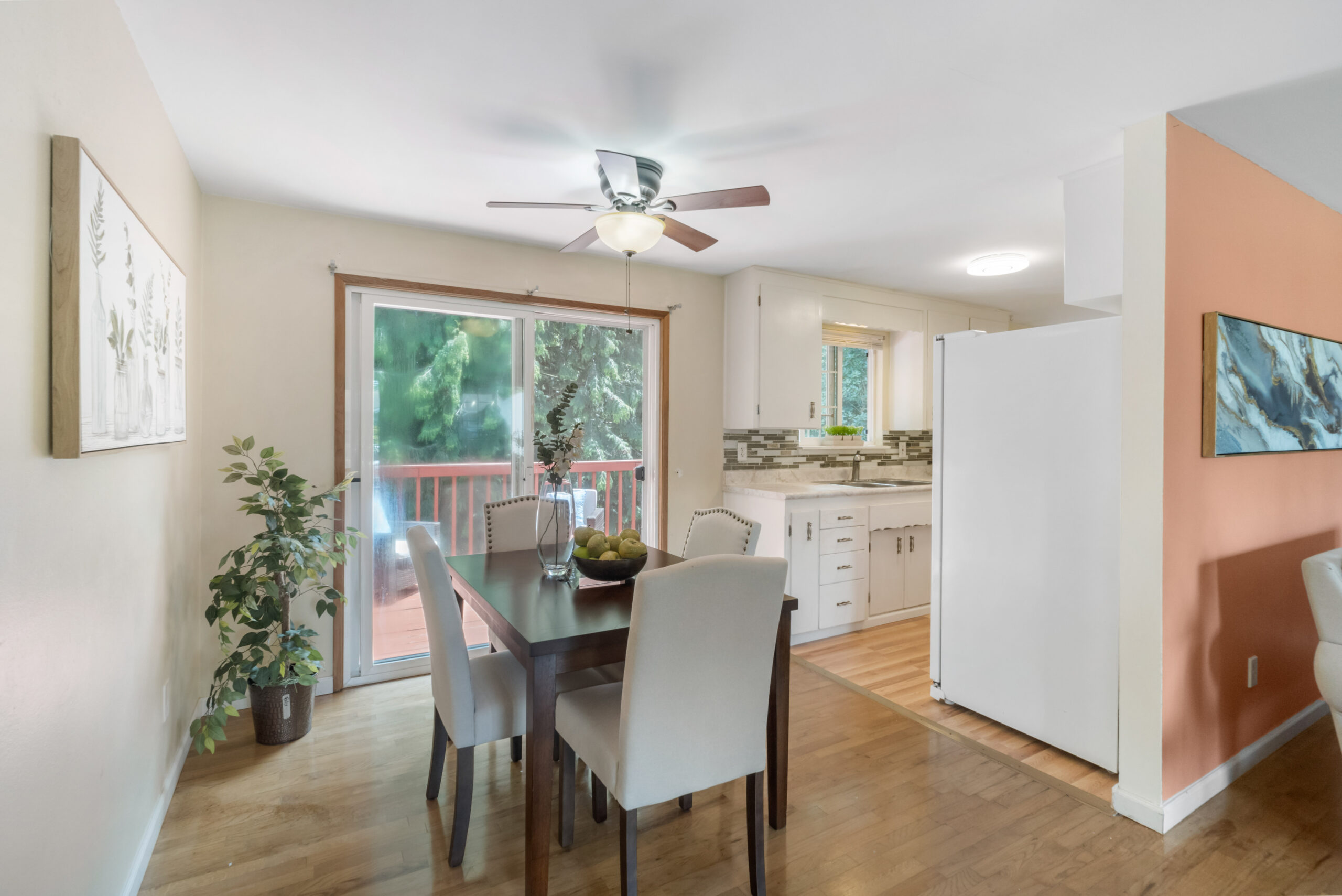 Dining area with slider to deck, opening into kitchen, upstairs unit of Auburn duplex