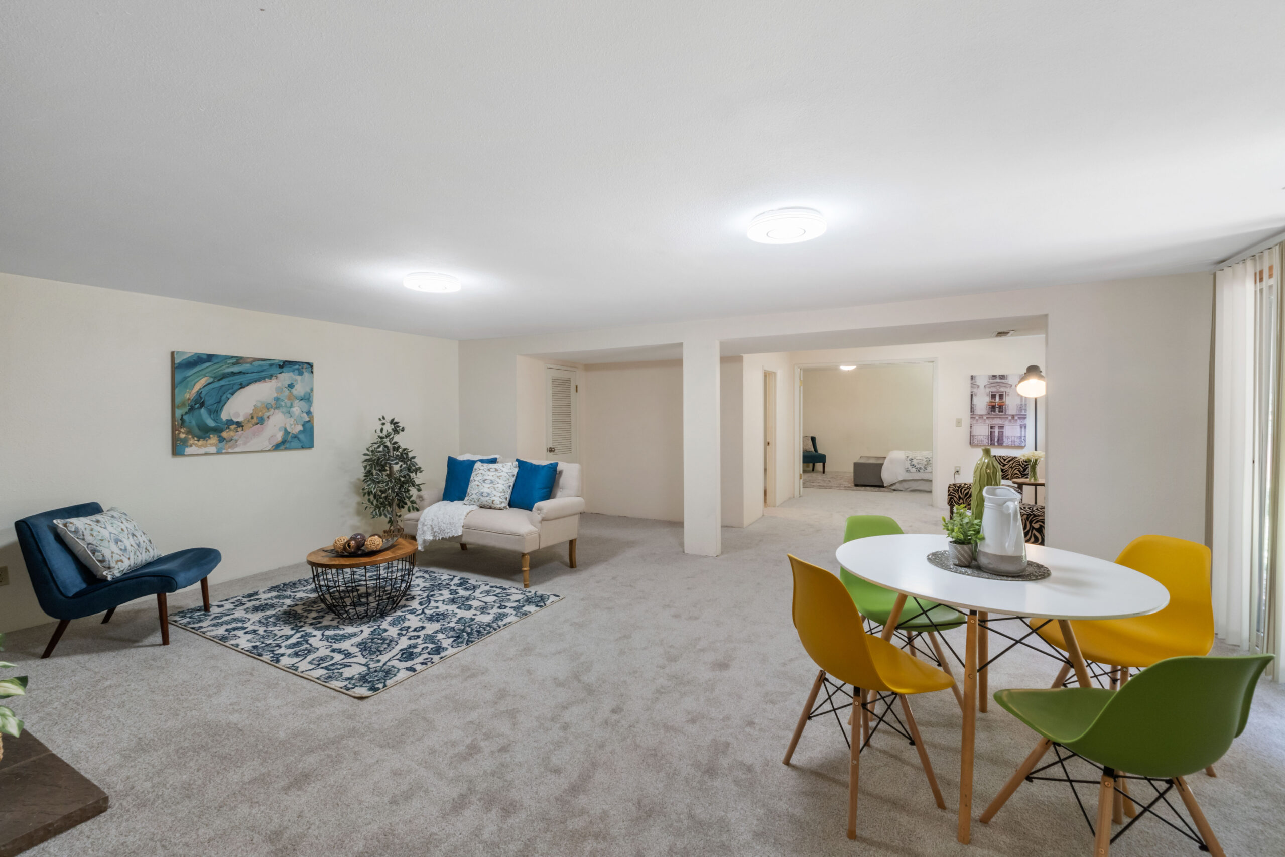 Living and dining area of the downstairs unit in the Auburn duplex, with view to bedroom beyond