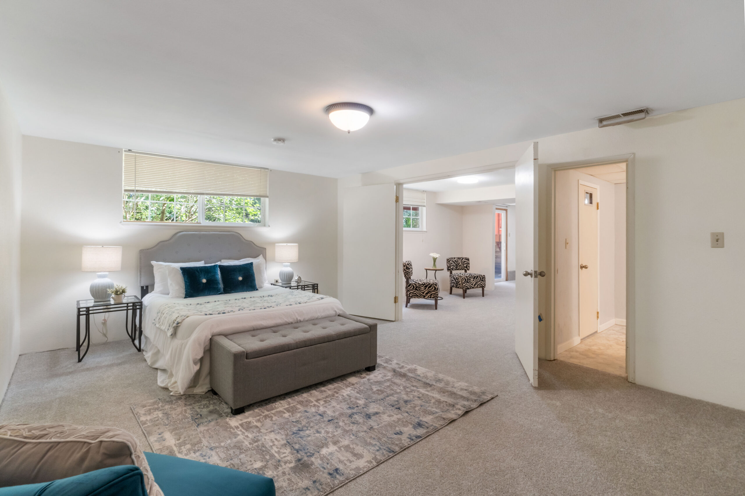 Downstairs unit bedroom with sitting area beyond, in the Auburn duplex's self-contained lower level