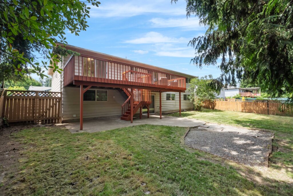 Rent to own Auburn WA duplex at 29356 38th Pl S, showing the separate lower-unit entrance and large deck