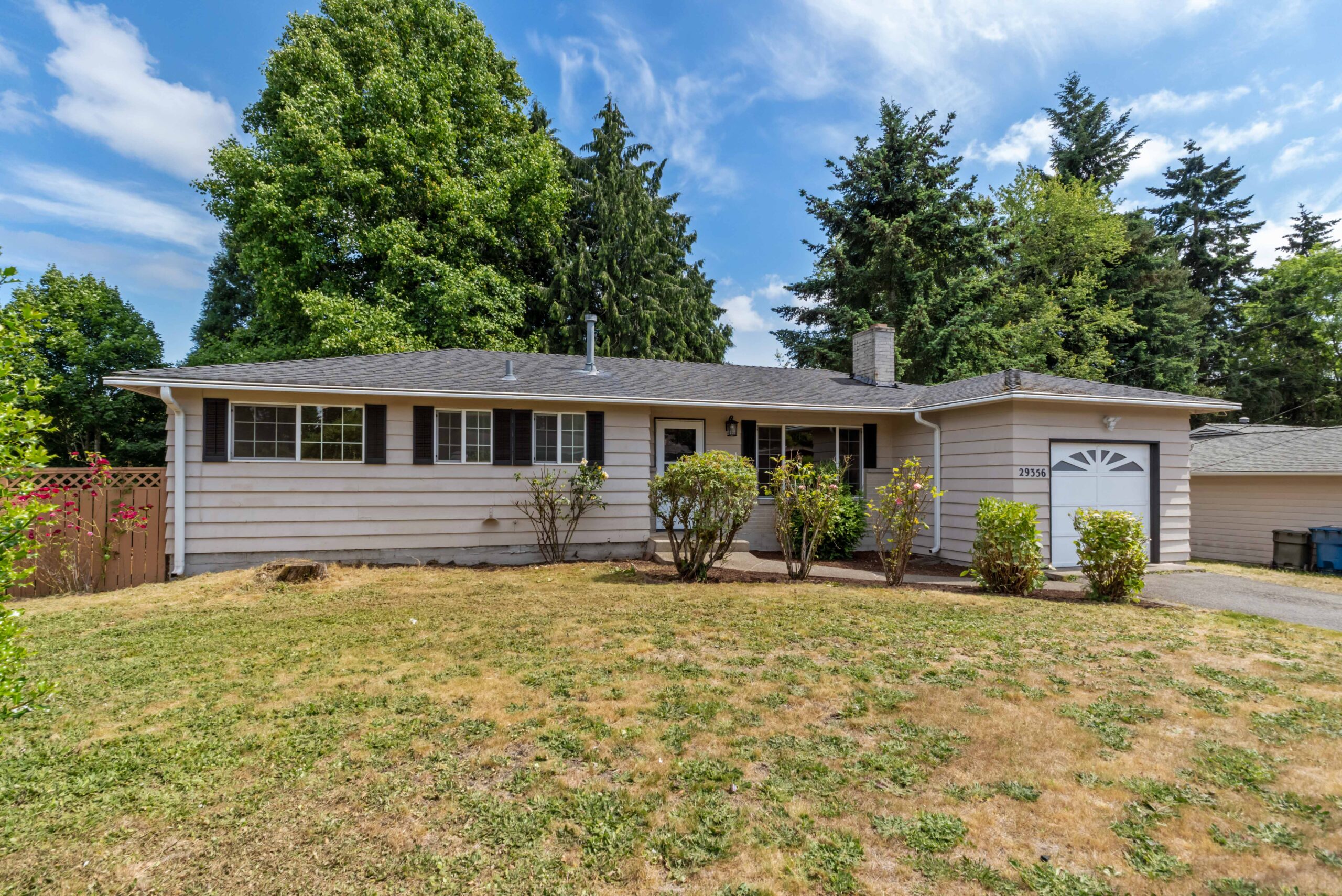 Front exterior of the Auburn duplex, showing separate entrances, garage, and large front lawn