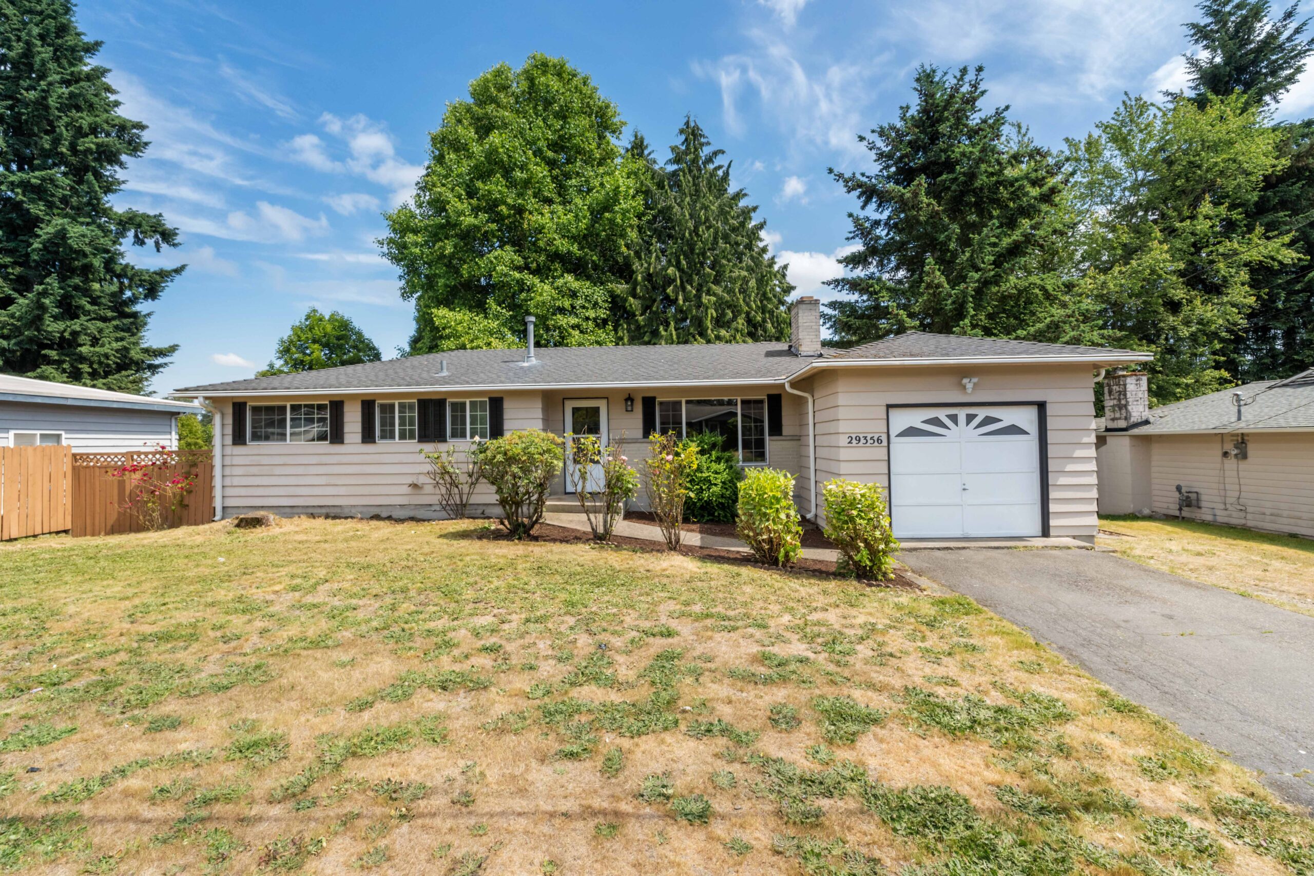 Front exterior of the split-entry duplex at 29356 38th Pl S, Auburn, with garage, driveway and lawn