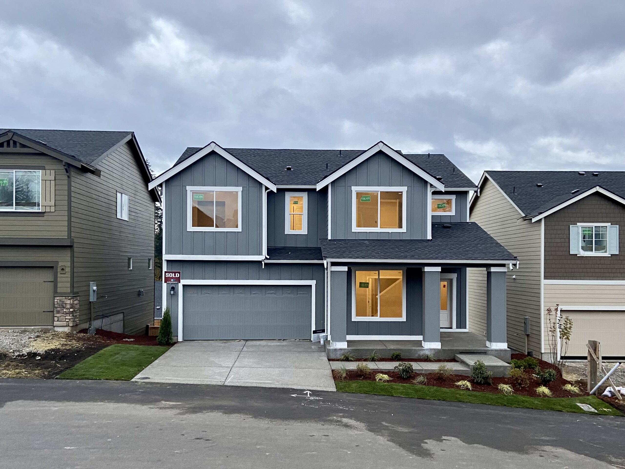 Front exterior of the Thrush Ct rent-to-own home in Port Orchard, two-story with attached garage